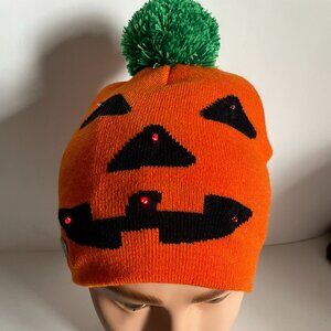 Halloween hat Toque with a jack-o'lantern face and green pompom, flashing lights